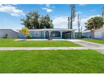 Newly renovated light teal home with a spacious yard at 6570 Coliseum Blvd, Port Charlotte, FL 33981