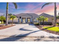 Stunning home featuring a tile roof, manicured landscaping, and a circular driveway perfect for entertaining at 192 Grand Oak Cir, Venice, FL 34292