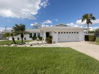 Single-story home with a two-car garage and well-maintained lawn at 514 Palm Ave, Nokomis, FL 34275