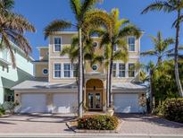 Three-story house with three-car garage, and palm trees at 737 Shakett Creek Dr, Nokomis, FL 34275