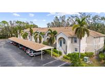 Exterior view of building with parking and landscaping at 8315 Glenrose Way # 1414, Sarasota, FL 34238