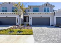 Two-story home with gray siding and a two-car garage at 17560 Boracay Ct # 202, Venice, FL 34293