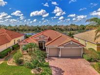 One-story house with tile roof and two-car garage at 11356 Dancing River Dr, Venice, FL 34292