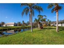 Property backs up to a peaceful canal with lush landscaping at 172 Southampton Pl # 346, Venice, FL 34293