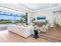 Bright living room with modern furnishings, hardwood floors, and stunning water views at 1109 Bayshore Rd, Nokomis, FL 34275