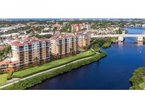 Beautiful aerial view of waterfront condos featuring lush landscaping and convenient bridge access at 147 Tampa E Ave # 202, Venice, FL 34285