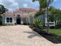 Two-story home with tile roof and landscaping at 1724 Grande Park Dr, Englewood, FL 34223