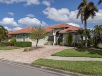 House exterior featuring a brick driveway and lush landscaping at 4245 Via Del Villetti Dr, Venice, FL 34293