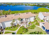 Aerial view of waterfront condo community with lush landscaping and private balconies at 984 Bird Bay Way # 255, Venice, FL 34285