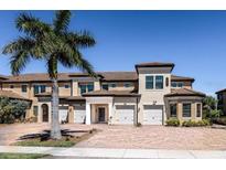 Beautiful 2 story townhome with 2 car garage, landscaped grounds, and brick pavers at 10055 Crooked Creek Dr # 103, Venice, FL 34293