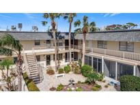 Quaint courtyard with a garden, seating, and a central fountain at 200 Park N Blvd # 103, Venice, FL 34285