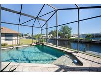 Relaxing pool area with canal view and screened enclosure at 3390 Dover Dr, Punta Gorda, FL 33983