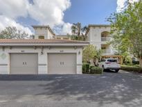 Two-story condo building with attached garages and landscaping at 900 San Lino Cir # 922, Venice, FL 34292