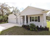 One-story home with attached garage and covered porch at 15467 Maynard Ave, Port Charlotte, FL 33953