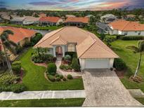 Attractive single-Gathering home with tile roof, landscaped yard, and paver driveway at 4361 Via Del Santi, Venice, FL 34293