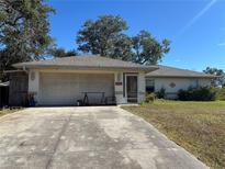 Single-story house with attached garage and driveway at 1114 S Narramore St, North Port, FL 34287