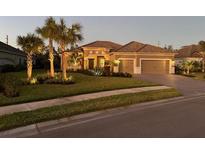 Attractive single-story home with landscaping and a three-car garage at 169 N Cayman Isles Blvd, Englewood, FL 34223