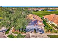 Aerial view of a house and neighborhood with golf course at 4665 Whispering Oaks Dr, North Port, FL 34287