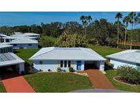 Cute and cozy single story home with light colored tile roof and landscaped yard at 618 Circlewood Dr # S2-15, Venice, FL 34293