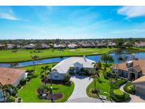 Luxury home on golf course with pool and lush landscaping at 857 Blue Crane Dr, Venice, FL 34285