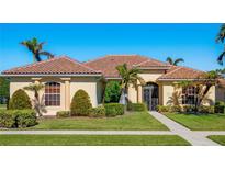 Beautiful one-story home with tile roof, lush landscaping, and a welcoming entryway at 995 Chickadee Dr, Venice, FL 34285