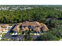 Aerial view of condo community showing building and landscaping at 2078 Oakridge Cir # A7, Venice, FL 34293