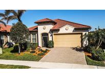 One-story home with tile roof, landscaping, and two-car garage at 23739 Waverly Cir, Venice, FL 34293