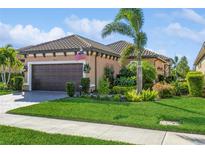 Beautiful one-story home with a landscaped yard and a two-car garage at 5837 Semolino St, Nokomis, FL 34275