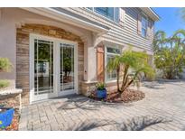 Charming home entrance featuring stone accents, double doors and meticulous landscaping at 6405 Gulf Dr, Holmes Beach, FL 34217