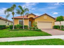 Attractive one-story house with a two-car garage and landscaped lawn at 10185 Colubrina Dr, Venice, FL 34293