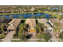 Aerial view of houses with tile roofs near a lake at 13812 Alafaya St, Venice, FL 34293