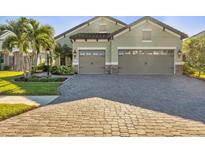 Attractive home with three-car garage and paver driveway at 11897 Hunters Creek Rd, Venice, FL 34293