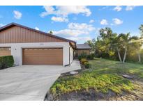 Two-car garage and well-manicured lawn at 1709 Curry Ave # 83, Nokomis, FL 34275