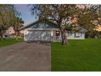 Ranch-style home with a spacious yard and driveway at 2281 Mars Rd, Venice, FL 34293