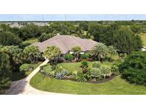 Inviting home with lush landscaping and a paved driveway at 3200 Rowland Dr, Punta Gorda, FL 33980