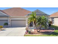 Charming villa with 2-car garage, attractive landscaping, and welcoming front porch at 5255 Athens Way, Venice, FL 34293