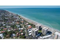Aerial view of beachfront property, showing two high-rise buildings and surrounding area at 629 Alhambra Rd # 704, Venice, FL 34285