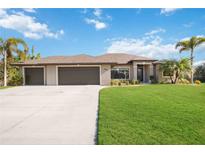 Attractive single-story home with three-car garage and lush lawn at 2665 Alamander Ave, Englewood, FL 34223