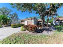 Front view of a house with two-car garage and lush landscaping at 4417 Park Lake N Ter, Bradenton, FL 34209