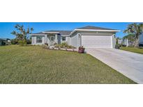 Newly constructed home with a 2-car garage and well-manicured lawn at 6297 Drucker Cir, Port Charlotte, FL 33981