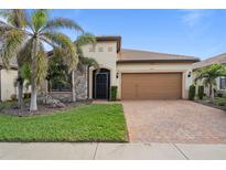 Single-story home with attractive landscaping and a two-car garage at 13807 Karina St, Venice, FL 34293