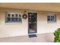 Inviting condo entry with a wreath and neutral color scheme at 2260 Stickney Point Rd # 303, Sarasota, FL 34231