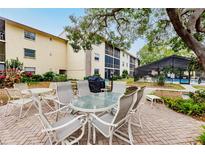 Community patio area with table and chairs at 2260 Stickney Point Rd # 303, Sarasota, FL 34231