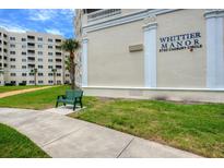 Whittier Manor building exterior, showing landscaping and a walkway at 3730 Cadbury Cir # 400, Venice, FL 34293