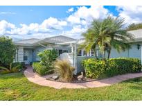 Well-maintained house exterior with walkway, landscaping, and a gate at 452 Wexford Cir # 105, Venice, FL 34293