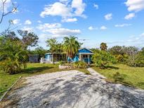 Charming blue house with a spacious yard and carport at 4533 Church St, Punta Gorda, FL 33980