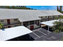 Condo building with parking and covered walkways at 509 Parkdale Mews # 509, Venice, FL 34285