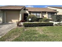 Charming single story villa with a well maintained lawn and mature shrubbery at 1211 Capri Isle Blvd # 123, Venice, FL 34292
