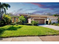 Beautiful single-story home featuring a well-manicured lawn and a two-car garage at 107 Corte Del Rosa, Venice, FL 34285