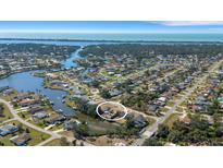 Expansive aerial view of a waterfront community with lush landscaping and a serene coastal backdrop at 1985 Fairview Dr, Englewood, FL 34223